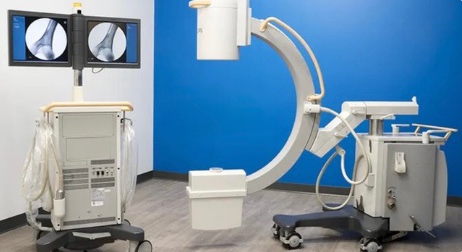 The same C-arm and monitor cart from the rear